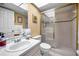 Bright bathroom with shower, white tile and a vanity with sink at 14692 Seminole Trl, Seminole, FL 33776