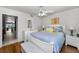 Bright bedroom with a ceiling fan, hardwood floors, and ensuite bathroom at 14692 Seminole Trl, Seminole, FL 33776