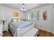 Bright bedroom with a ceiling fan, hardwood floors and large window at 14692 Seminole Trl, Seminole, FL 33776