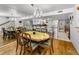 Spacious dining room with chandelier and mirror, adjacent to kitchen and living areas at 14692 Seminole Trl, Seminole, FL 33776