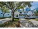 Charming townhome exterior featuring white siding, attached garage, and manicured landscaping at 14692 Seminole Trl, Seminole, FL 33776