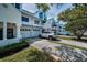 Charming townhome featuring white siding, attached garage, and carefully designed landscaping at 14692 Seminole Trl, Seminole, FL 33776
