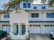 Charming townhouse exterior featuring a well-manicured yard, attached garage, and inviting entrance at 14692 Seminole Trl, Seminole, FL 33776