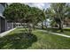 Exterior view showcasing the lush green lawn and walkway of the condo community at 14692 Seminole Trl, Seminole, FL 33776