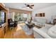 Inviting living room with hardwood floors, comfortable seating, and access to a screened lanai at 14692 Seminole Trl, Seminole, FL 33776
