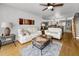 Comfortable living room with two sofas, ceiling fan, and hardwood floors at 14692 Seminole Trl, Seminole, FL 33776