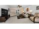 Spacious living room with neutral furniture, a ceiling fan, and sliding glass doors at 14692 Seminole Trl, Seminole, FL 33776