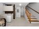Neutral-toned living room with a staircase and a beverage center at 14692 Seminole Trl, Seminole, FL 33776