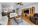 Open living room with hardwood floors, media center, ceiling fan, and staircase at 14692 Seminole Trl, Seminole, FL 33776