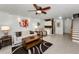 Living room featuring a ceiling fan, staircase, and kitchenette at 14692 Seminole Trl, Seminole, FL 33776