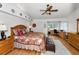 Bright main bedroom with hardwood floors, ensuite, and desk with chair at 14692 Seminole Trl, Seminole, FL 33776