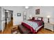 Comfortable main bedroom with an ensuite and a decorative red and white bedspread at 14692 Seminole Trl, Seminole, FL 33776
