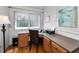 Office nook featuring hardwood floors, built in desk and cabinets, window, natural light and an office chair at 14692 Seminole Trl, Seminole, FL 33776