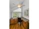 Bright office features hardwood floors, built in desk and cabinets, window, natural light, and office chair at 14692 Seminole Trl, Seminole, FL 33776