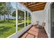 The screened patio with brick floor provides an outdoor retreat overlooking green space at 14692 Seminole Trl, Seminole, FL 33776