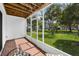 The screened patio with brick floor has palm trees outside and provides outdoor retreat at 14692 Seminole Trl, Seminole, FL 33776
