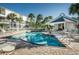 A community pool is surrounded by palm trees, lounge chairs, and a clubhouse at 14692 Seminole Trl, Seminole, FL 33776