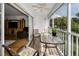 Outdoor screened lanai with comfortable chairs, table, and a view of the lush landscaping and nearby homes at 14692 Seminole Trl, Seminole, FL 33776