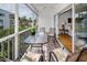 Relaxing screened lanai with patio furniture, offering scenic views of the surrounding greenery at 14692 Seminole Trl, Seminole, FL 33776