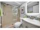 Modern bathroom features a glass shower door, tiled shower walls, and a vanity with a mirrored cabinet at 14723 Seminole Trl, Seminole, FL 33776