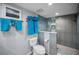 Beautiful bathroom features a glass-enclosed shower, modern tile and organized towel racks at 14723 Seminole Trl, Seminole, FL 33776