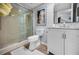 Clean bathroom with glass-enclosed shower, white toilet, and stylish vanity with marble countertop at 14723 Seminole Trl, Seminole, FL 33776