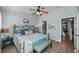 Serene bedroom features a ceiling fan, wood floors and ensuite access at 14723 Seminole Trl, Seminole, FL 33776