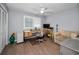 Cozy bedroom featuring a ceiling fan, work desk, bright light, and a striped sofa at 14723 Seminole Trl, Seminole, FL 33776