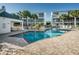 Beautiful community pool with pristine blue water, surrounded by lush landscaping and comfortable lounge chairs at 14723 Seminole Trl, Seminole, FL 33776