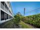 Well-maintained exterior of the property with lush landscaping and screened-in balconies at 14723 Seminole Trl, Seminole, FL 33776