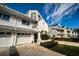 Inviting townhouse showing a well-kept lawn, tidy landscaping, and an attached garage at 14723 Seminole Trl, Seminole, FL 33776
