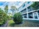 Well-maintained exterior of the property with lush landscaping and screened-in balconies at 14723 Seminole Trl, Seminole, FL 33776