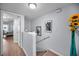 Hallway with access to rooms and stairs, adorned with sunflowers and artwork at 14723 Seminole Trl, Seminole, FL 33776