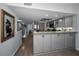Open kitchen layout featuring gray cabinets, modern appliances, and seamless flow to other living areas at 14723 Seminole Trl, Seminole, FL 33776