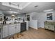 Open-concept kitchen with stainless steel dishwasher and sink area, connecting to the staircase and living spaces at 14723 Seminole Trl, Seminole, FL 33776