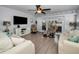 Cozy living room features sliding doors to the lanai and comfortable seating for relaxing and entertaining at 14723 Seminole Trl, Seminole, FL 33776