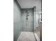 Walk in shower with modern shower head, tiled walls, and patterned flooring at 14723 Seminole Trl, Seminole, FL 33776