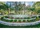 Elegant Tara Cay Sound signage is enhanced by beautiful landscaping, palm trees, and lush greenery at 14723 Seminole Trl, Seminole, FL 33776