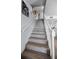 Open stairway with updated treads and white railings leading up to the main floor at 14723 Seminole Trl, Seminole, FL 33776