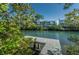 Scenic waterfront view featuring private dock access and lush green landscaping in a peaceful setting at 14723 Seminole Trl, Seminole, FL 33776