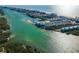 Stunning waterfront vista with turquoise water and charming townhouses nestled along the coastline at 14723 Seminole Trl, Seminole, FL 33776