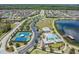 Aerial view of community with pool, tennis courts, playground, and walking trails at 18860 Beautyberry Ct, Lutz, FL 33558