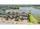 Aerial view of townhomes with brick driveways and a lake view with fountain in the background at 18860 Beautyberry Ct, Lutz, FL 33558