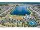 Beautiful aerial view of a community with a lake, playground, pool, and tennis and basketball courts at 18860 Beautyberry Ct, Lutz, FL 33558