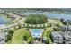 Aerial view of a community pool with landscaping and a nearby roundabout at 18860 Beautyberry Ct, Lutz, FL 33558