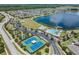 Aerial view of community amenities featuring a pool, tennis courts, and clubhouse at 18860 Beautyberry Ct, Lutz, FL 33558