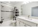 Bright bathroom featuring a vanity sink and tub-shower combination with modern fixtures at 18860 Beautyberry Ct, Lutz, FL 33558