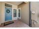 Inviting entryway featuring a teal front door, brick flooring, and modern hardware at 18860 Beautyberry Ct, Lutz, FL 33558