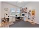 Bright home office with large windows, built-in desk, and plenty of storage space at 18860 Beautyberry Ct, Lutz, FL 33558
