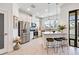 Bright kitchen with stainless steel appliances, a breakfast bar with seating, and modern pendant lighting at 18860 Beautyberry Ct, Lutz, FL 33558